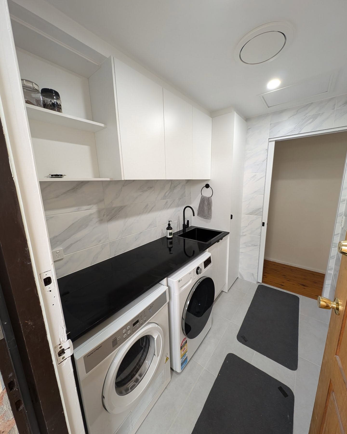 Completed bathroom renovation with timber vanity and grey tiling
