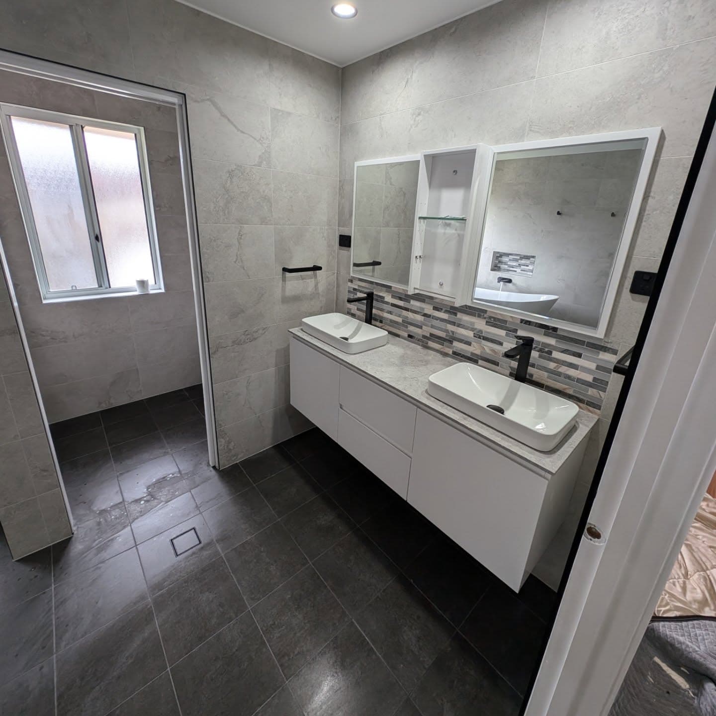 Renovated family bathroom with double vanity and feature tiling